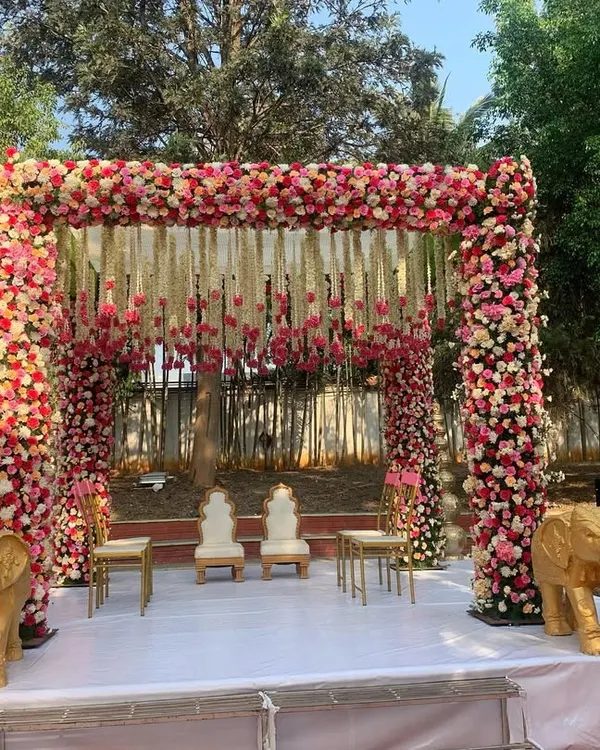 This breathtaking floral mandap, set against an open lawn, is the perfect example of how we blend tradition with natural beauty to create a sacred space for your vows.