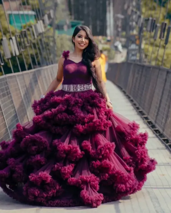 Our "cloud" gown in a deep plum color is a showstopper. The voluminous, textured skirt creates a high fashion look perfect for a unique photoshoot or event.
