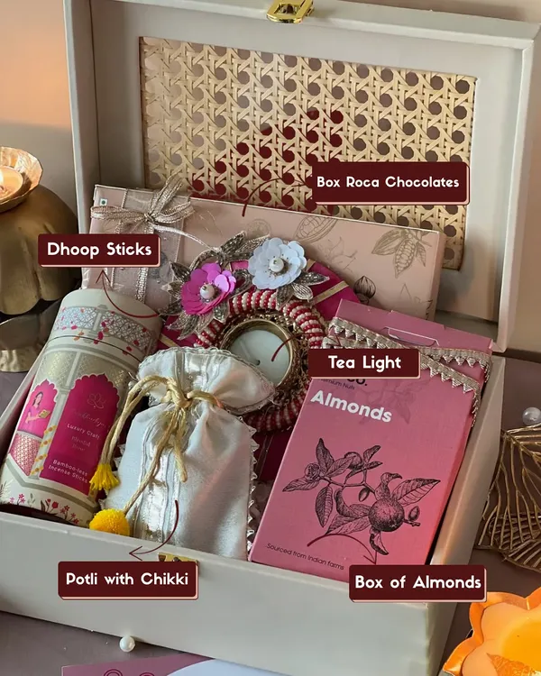 Here’s a look inside my signature Diwali rattan box. It’s a treasure trove of festive goodies, including aromatic dhoop sticks, a decorative tea light, roka chocolates, almonds, and a potli filled with chikki.