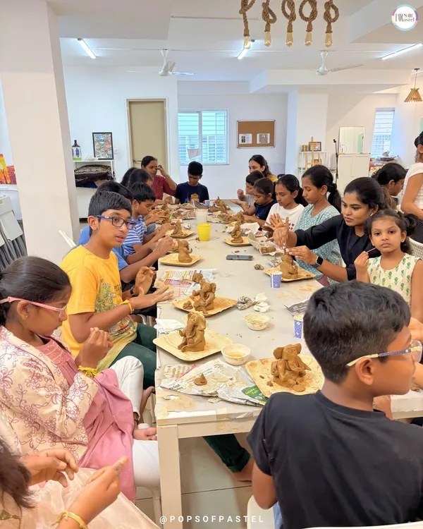 A wide view of our clay Ganesha workshop, packed with enthusiastic participants of all ages, each focused on sculpting their own divine idol.