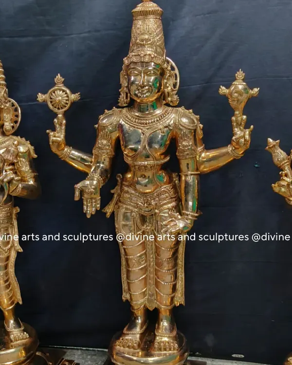 This is the central figure of Lord Balaji from a three-piece set, cast in polished bronze. He is shown with four arms, holding the Sudarshana Chakra and Panchajanya conch, with his lower hands in the varada and katyavalambita mudras.
