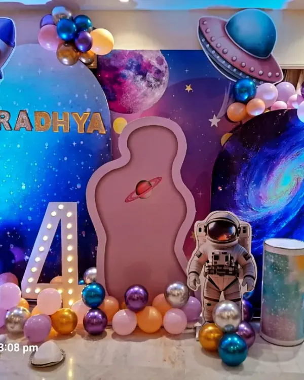 This is a complete outer space adventure I created for a 4th birthday. The setup includes a galaxy-themed backdrop, custom rocket and planet cutouts, an astronaut figure, and a large balloon arch in cosmic colors to make the kids feel like they are on a real space mission.