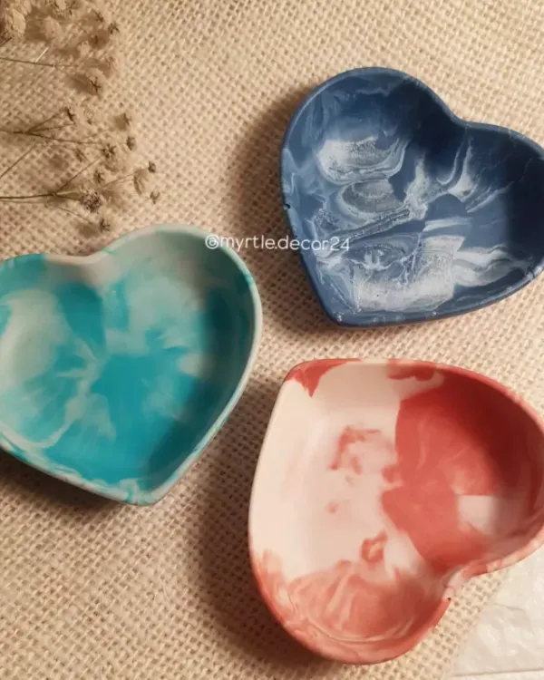 Our mini heart dishes in beautiful marbled shades of aqua, blue, and pink. These are the perfect little catch-alls for the small things you use daily, like rings and earrings, and they make any space look extra cute.