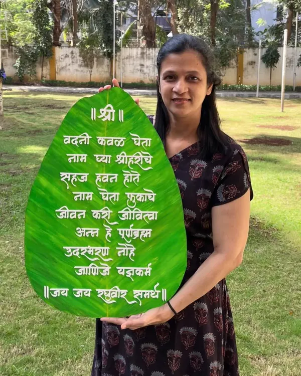 Here I am with a large, 24-inch 'Vadani Kaval' wall hanging, custom-made for a client in the US. This traditional Marathi prayer for mealtime looks beautiful in a dining area.