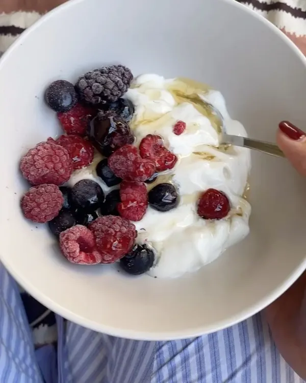 A perfect post-training recovery meal doesn't have to be complicated. This bowl of Greek yogurt with mixed berries and a drizzle of honey provides a great balance of protein to repair muscles and carbohydrates to replenish energy stores. Plus, the antioxidants in the berries help reduce inflammation.
