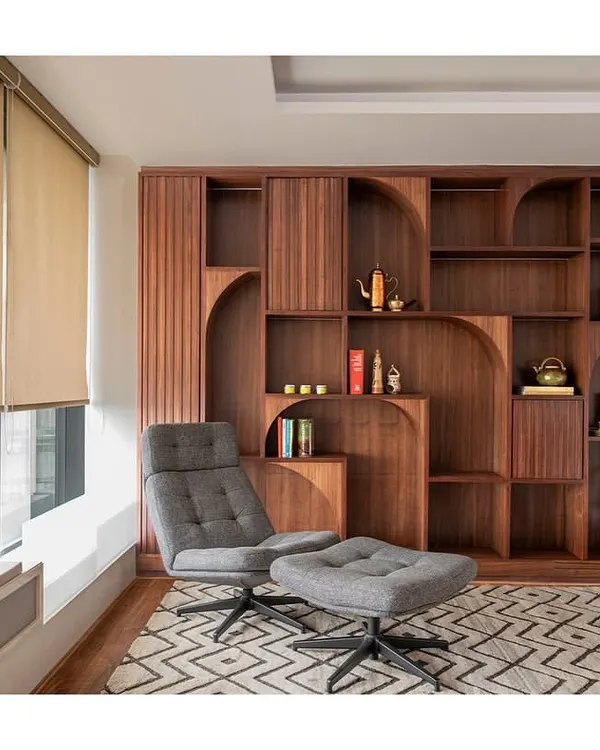 The wellness zone in 'The Office with A View' is a quiet, secluded room for staff to unplug. It features comfortable furniture, a custom bookshelf, and a window seat with an integrated planter box.