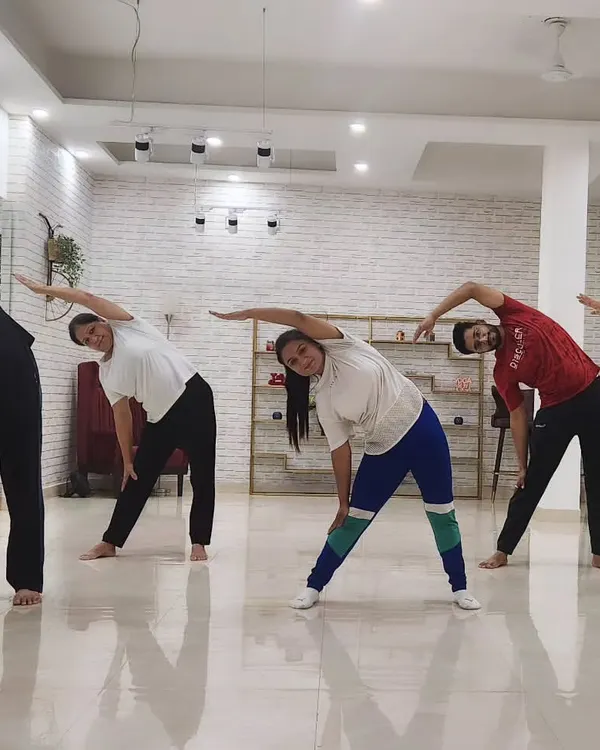 Leading a group class through Trikonasana, or triangle pose, at a local studio. Group sessions are full of energy and a great way to learn and grow together.