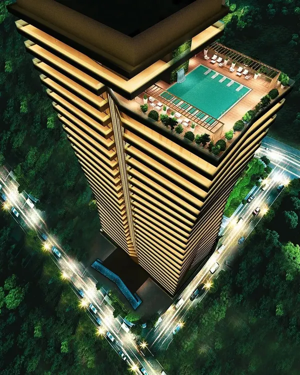 An aerial view of the Embrace Tower concept at night, showcasing its rooftop pool and distinctive, layered form. The design connects life and style, with wrap-around balconies that offer expansive views of the city.