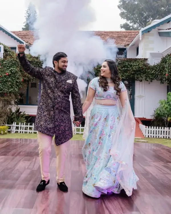 A picture-perfect moment for the couple at their Ooty destination wedding, with a color bomb adding a splash of fun to their photoshoot.
