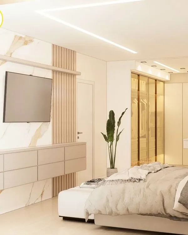 A luxurious master bedroom featuring a stunning combination of marble, wood fluting, and soft neutral tones. The design includes a floating TV console and a seamless connection to a walk-in wardrobe.