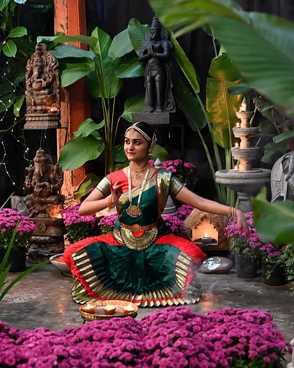 A scene from our store during the festive season, where our handcrafted decor is brought to life with flowers, light, and classical dance.