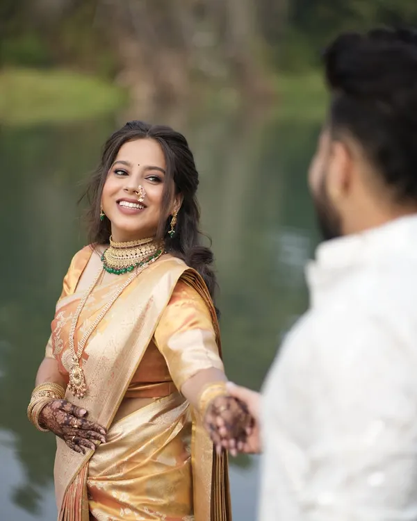 A beautiful client looking radiant at her engagement. I pre-pleated her golden silk saree to ensure it looked absolutely perfect for her entire event and photoshoot.