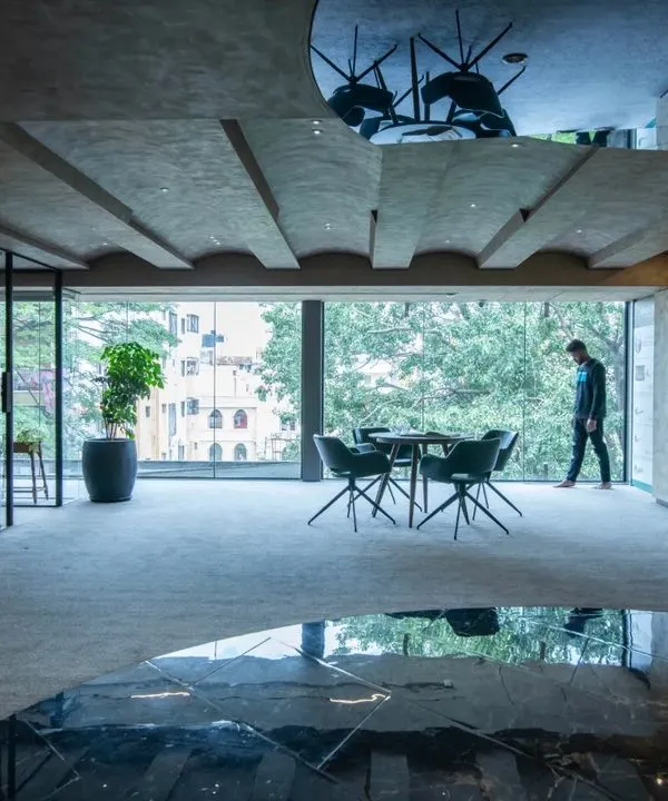 The bold and stylish Gala Showroom. The design uses reflections, dramatic lighting, and a dark, moody palette to create a sophisticated and immersive experience for visitors.