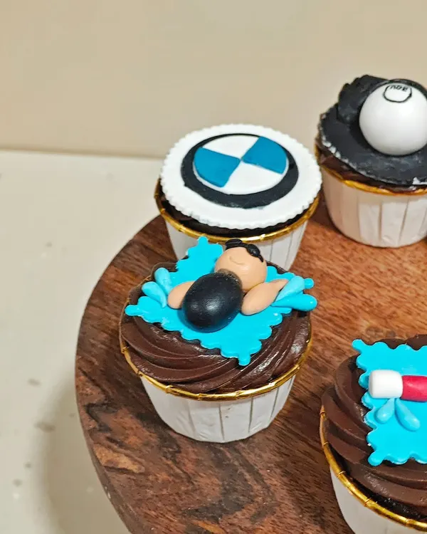 A close-up of the custom cupcakes I made for a couple. This one shows the swimmer and the BMW logo, representing their individual hobbies.
