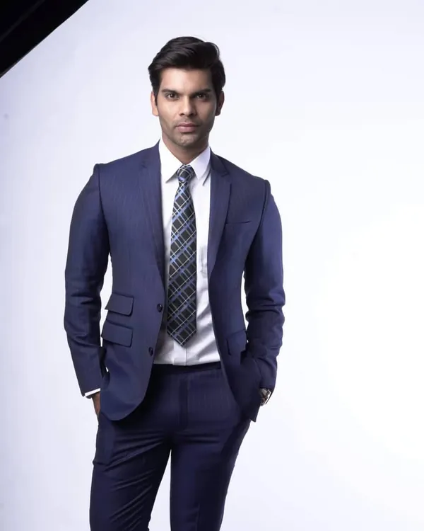 A classic navy pinstripe suit, custom tailored for a sharp, commanding presence. I focus on creating a perfect fit through the shoulders and waist, ensuring you look and feel your best in any business setting.