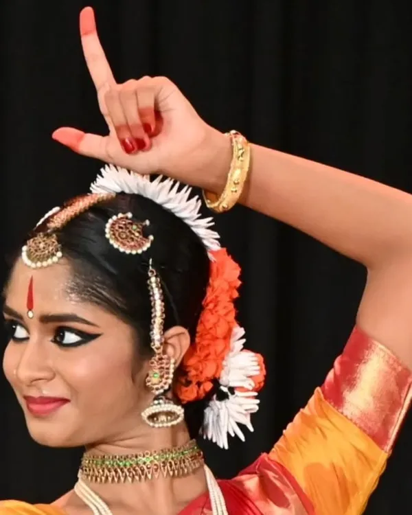 A student's arangetram is a reflection of the teacher's work. This image captures the grace and confidence of my shishya Anvita Jain, showcasing the intricate hand gestures or mudras that are fundamental to Bharatanatyam storytelling.