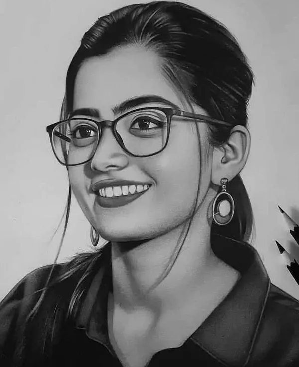 A graphite portrait of actress Rashmika Mandanna wearing glasses. I focused on capturing her bright smile and the realistic reflection in the lenses of her glasses.