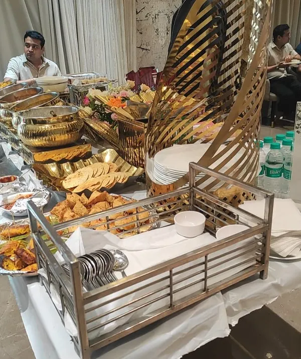 A wide view of one of our extensive buffet spreads for a housewarming party. You can see the variety of dishes, from appetizers to mains, all beautifully presented and ready for guests.