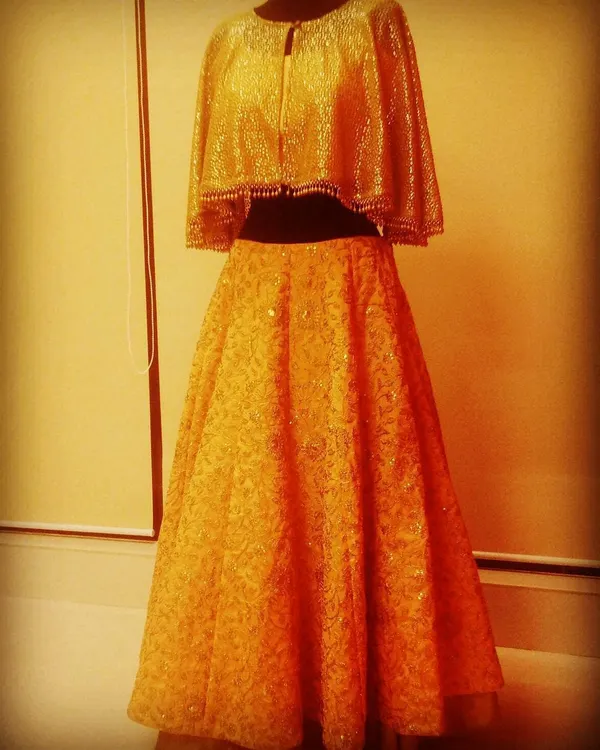 This golden cape-style lehenga is a classic that I've recreated many times on demand. The shimmering cape blouse paired with a flowing skirt is a showstopper, and seeing a happy customer wear it is the greatest reward.