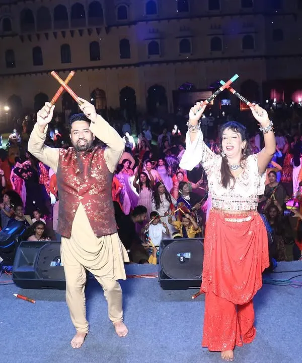 My partner Urvashi and I performing on stage at the 'City Dandiya Raas' event in Karnal. We love leading the crowd and sharing our energy with everyone.