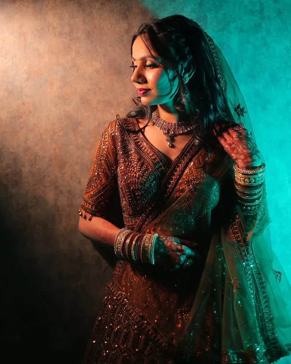 A moody ring ceremony portrait using split lighting with warm and cool tones to create a dramatic, cinematic feel.