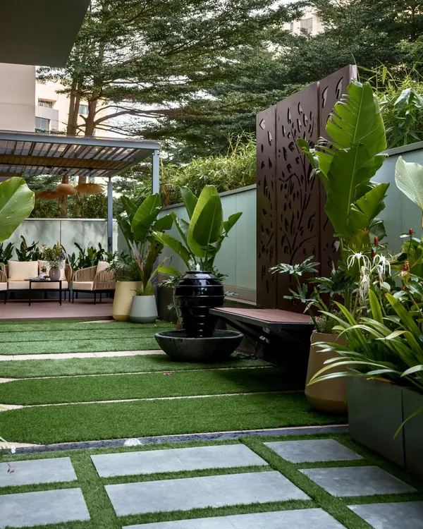 This urban retreat in Bangalore is one of our favorite transformations. We combined modern design with natural tranquility, incorporating a sleek pergola for shade, a soothing water feature, and lush tropical plants to create a private oasis. The space is perfect for quiet mornings and lively evenings, showing how a well-designed landscape becomes a true extension of your home.