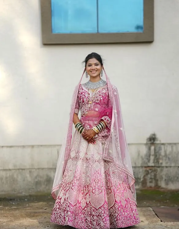 This is what wedding dreams are made of. Our bride looks absolutely radiant in this intricate pink and white ombre lehenga, perfect for a day wedding. We provide complete bridal lehenga rental services, including custom fitting, so you feel like a queen without spending a fortune.