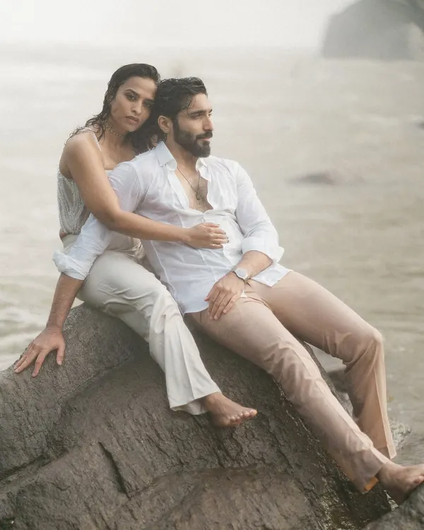 An intimate portrait set against the powerful mist of the Athirapilly waterfalls. The couple's gentle embrace and the raw, natural backdrop create a feeling of timeless romance and epic love.