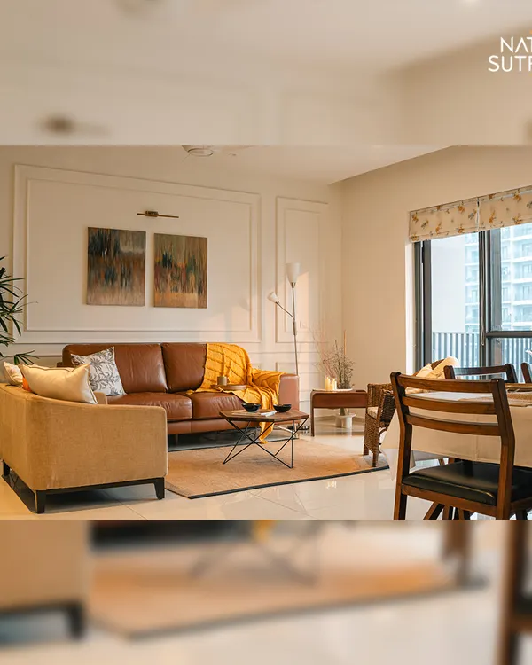 An overview of the open-plan living and dining area, designed to be bright, airy, and cohesive. The consistent color palette and classic wall mouldings unite the two zones, creating a spacious and harmonious environment.