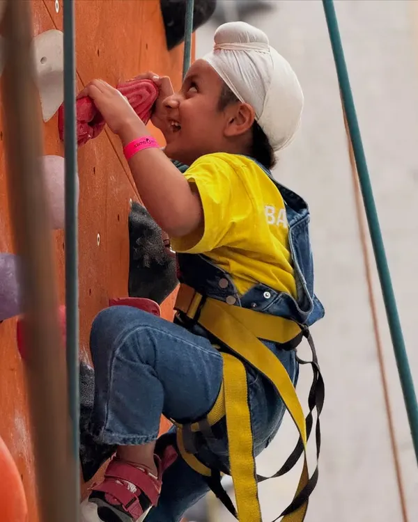 The smile says it all! A young climber in his harness beams with excitement, ready to take on the wall. We believe in building confidence through fun and safe challenges.
