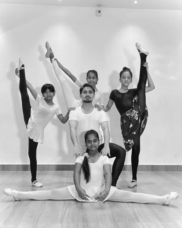 My advanced ballet students showcasing their flexibility and strength in a group pose. This demonstrates the results of dedicated training and practice in my classes.