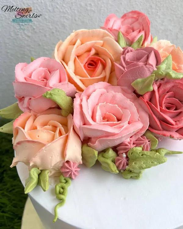We have a special place in our hearts for whipped cream roses. This close-up shows the delicate, multi-toned petals we pipe by hand to create a realistic and beautiful floral bouquet.