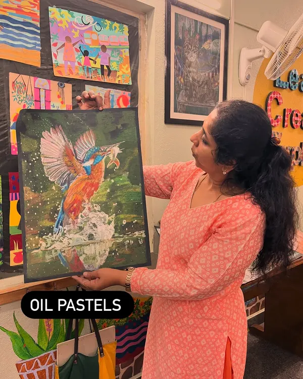I'm showcasing a student's impressive kingfisher painting done in oil pastels. We explore a wide range of mediums in the studio to help students find what they love.