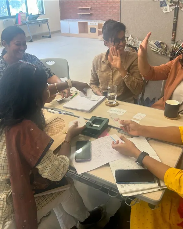 Teachers at DPS Hinjawadi engage in a hands-on activity during a 'Math from Scratch' workshop. The session is filled with laughter and collaboration, demonstrating that learning new teaching methods can be a joyful experience.