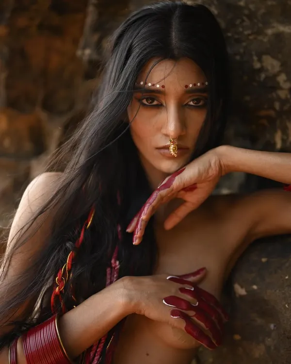 For this conceptual shoot, I created a dramatic reverse cat-eye and tribal-inspired dot work on the brow bone. The look is complemented by hand-painted red alta on the fingers, creating a raw and powerful visual.