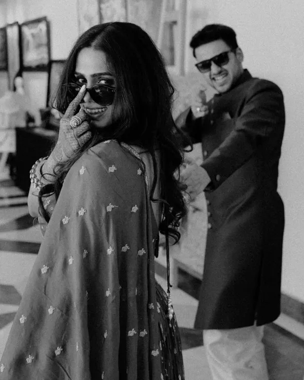 Partners in style, partners in crime. This playful black and white shot captures the cool, fun-loving dynamic of the couple, showing that wedding photos can be full of personality.