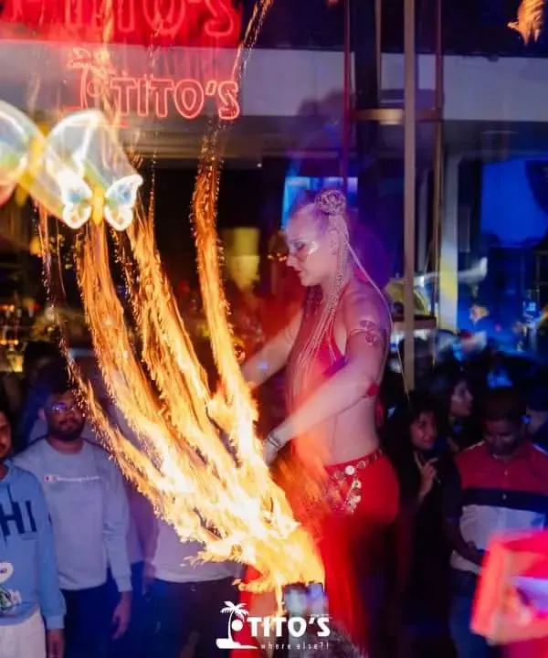 The party heats up with a spectacular fire performance at Tito's. I often incorporate live performers like fire dancers into my events to elevate the experience.