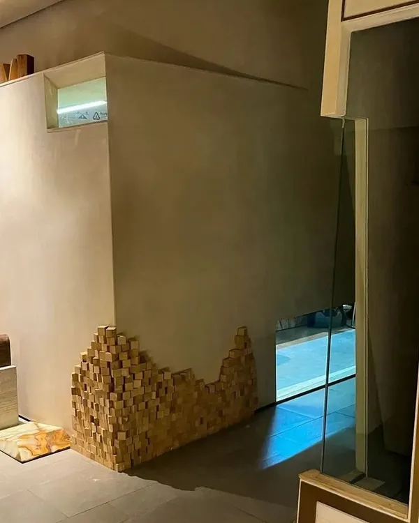 The entrance to our own DCA office in BKC, featuring a unique wall installation of wooden blocks. This sculptural detail represents our philosophy of building complex stories from simple, fundamental design elements.