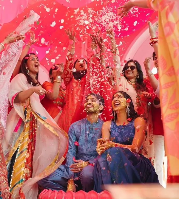 A 'phoolon ki holi' moment during a unique 'Gulabi Haldi' in Jaipur. I love creating unconventional themes that reflect the couple's personality while keeping the spirit of the tradition alive.