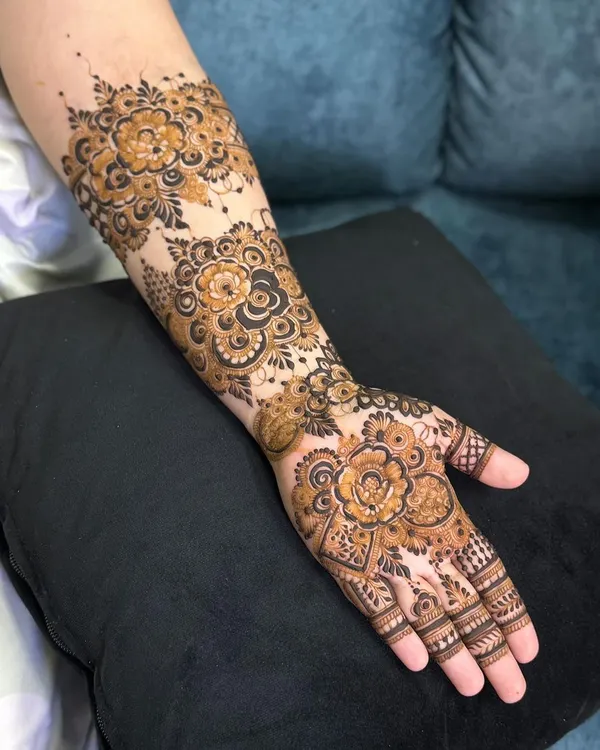 This design is a celebration of floral patterns, with large, detailed roses covering the back of the hand and forearm. The use of negative space makes the flowers pop.