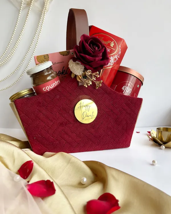 A rich, maroon quilted basket filled with luxury chocolates and gourmet jars. This hamper is designed to make a statement and is perfect for personal Diwali gifting.