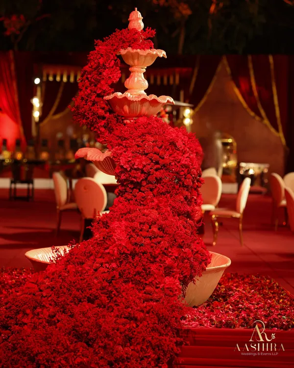 I believe in creating unforgettable moments, like this fountain overflowing with a cascade of thousands of crimson blooms. This is not just a centerpiece; it is a statement of passion and artistry, designed to be the heart of a truly opulent celebration.