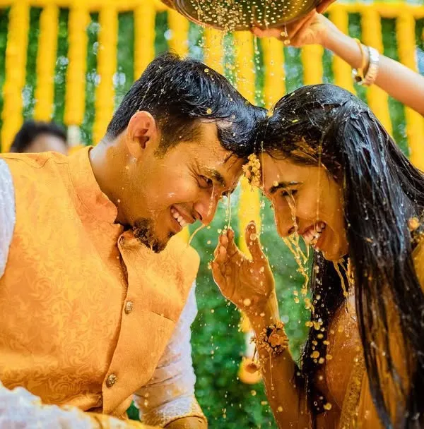 A beautiful, happy moment during a Haldi ceremony. We capture the joy and connection between the couple as they are showered with blessings and turmeric.