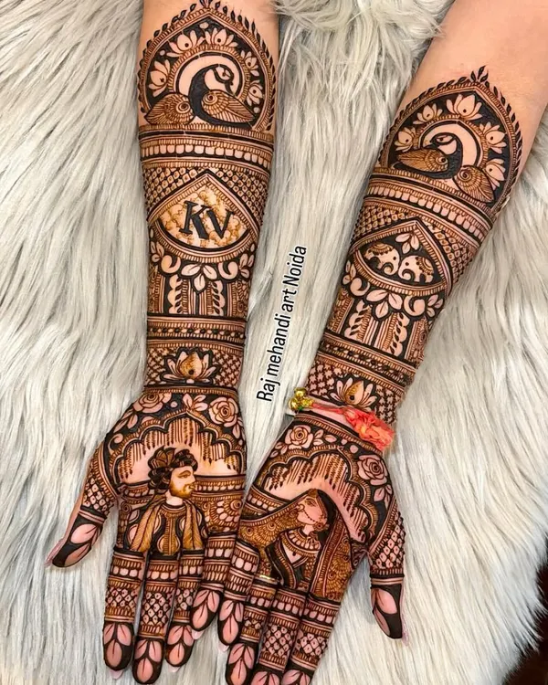 This is my specialty, turning your story into art. This custom bridal mehndi features detailed portraits of the couple on the palms, their initials "KV" elegantly placed on the forearms, and traditional peacock motifs, creating a design that is deeply personal and beautiful.