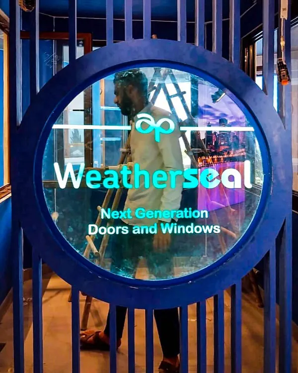 Custom branding is central to our experience center designs. Here, the 'Weatherseal' logo is integrated into a striking circular entryway, immediately immersing visitors in the brand's identity through bold colors and modern architectural signage.