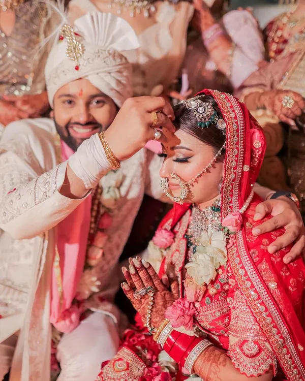 The sacred Sindoor moment. We captured the groom's smiling face as he applies the vermilion to his bride's forehead, a beautiful and significant ritual symbolizing their marriage.