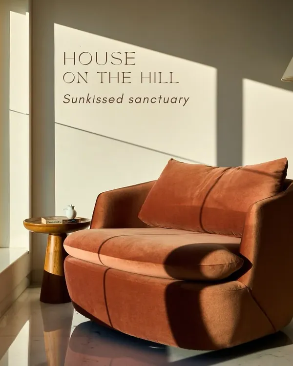 This sun-drenched corner from our 'House on the Hill' project perfectly embodies our design philosophy. We used a plush, burnt-orange velvet armchair to create a warm, inviting nook that feels like a private sanctuary, showcasing how we play with light, color, and texture to evoke a specific mood.