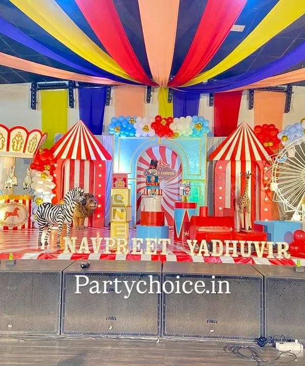 We brought a full-scale carnival to life for this birthday celebration. The stage decoration features classic red and white striped tents, a miniature Ferris wheel, life-sized animal props like a zebra and gorilla, and vibrant ceiling drapes to create an authentic big top atmosphere.