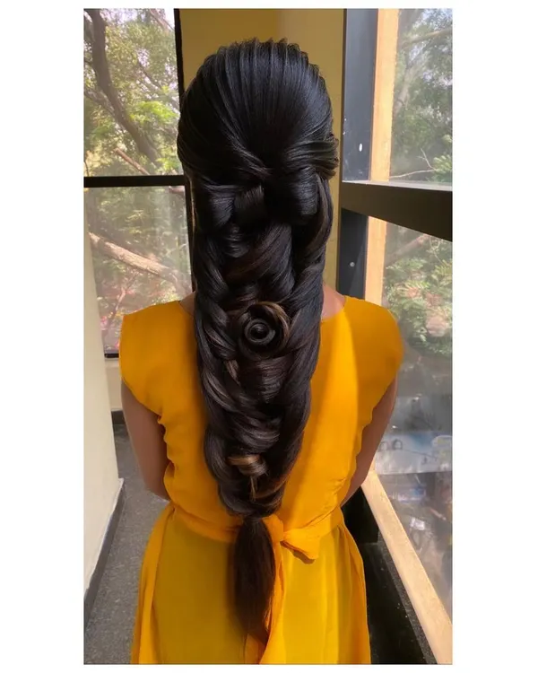 An advanced braiding technique taught in my course, featuring a 3D rose sculpted from hair within the braid. This style requires precision and is a true work of art.