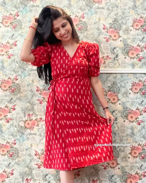 The Angrakha wrap dress in a striking red Ikat. This design is timeless, with puff sleeves and a tie-waist that gives it a beautiful, flattering shape.